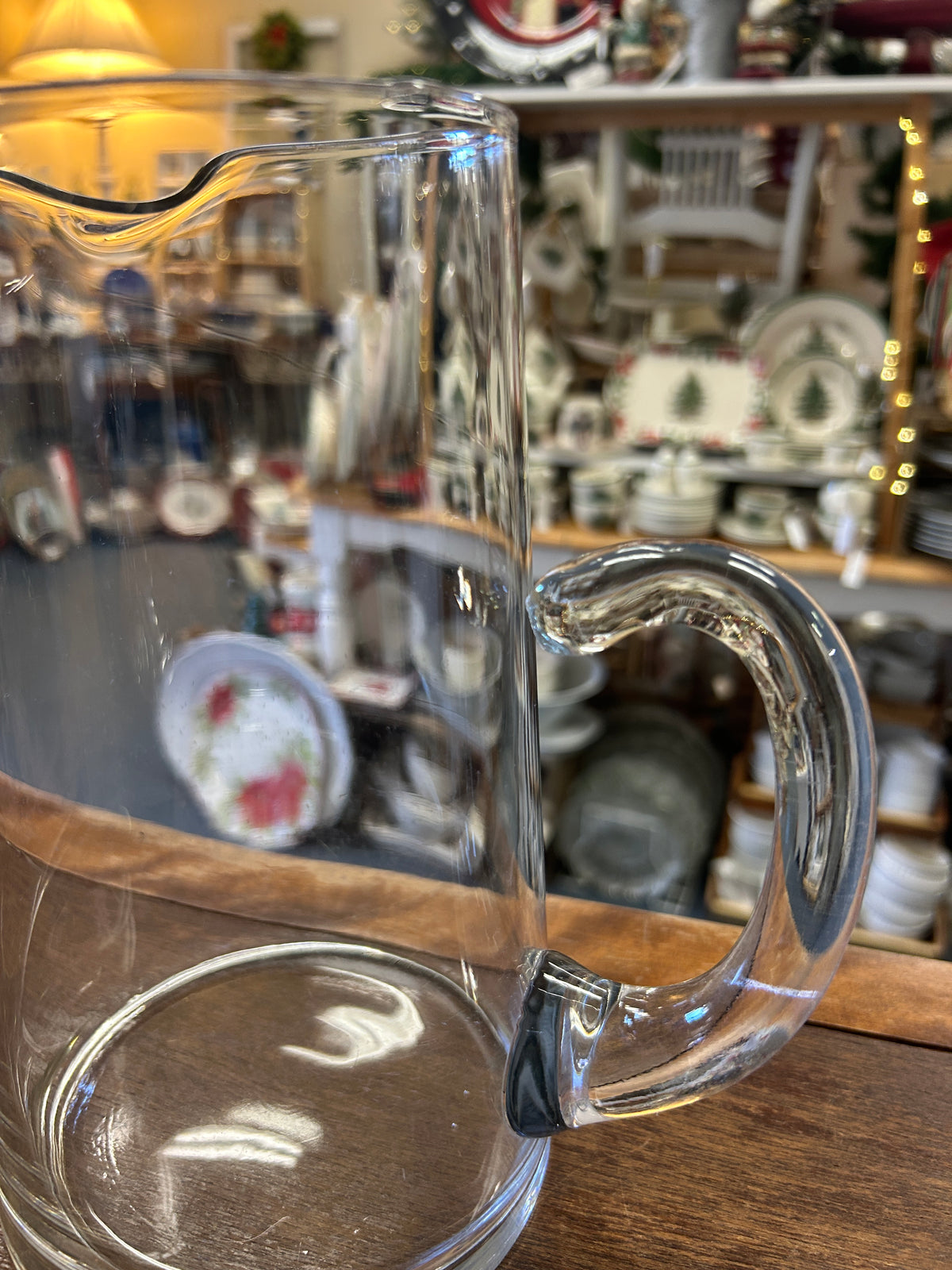 Clear glass pitcher from side, with loop handle and open top