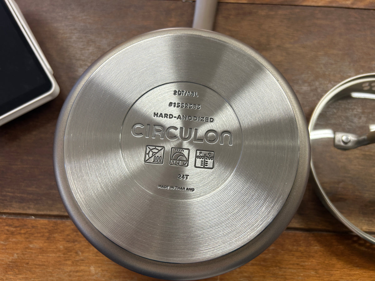 Circulon 2 qt sauce pan underside with product markings on brushed stainless base