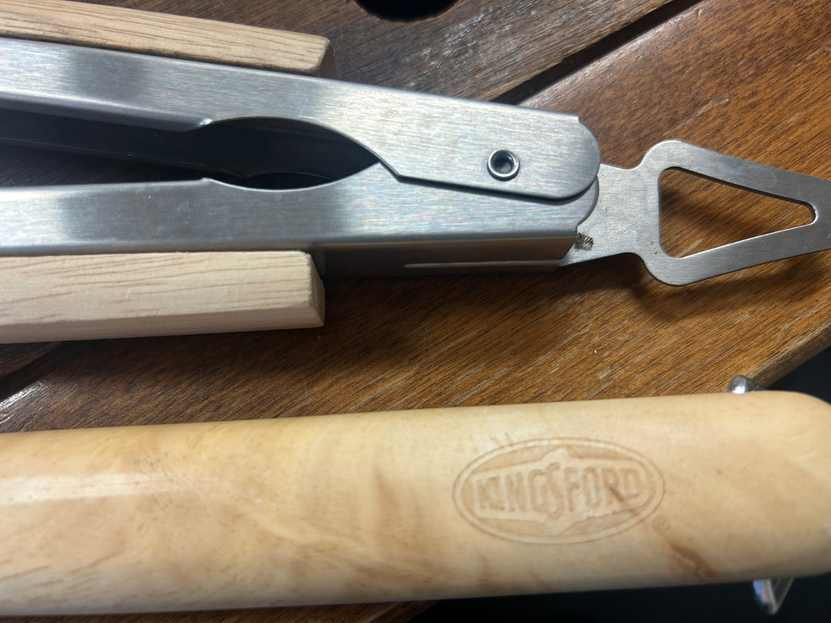 Metal spring tongs with wooden handle and hanging hole