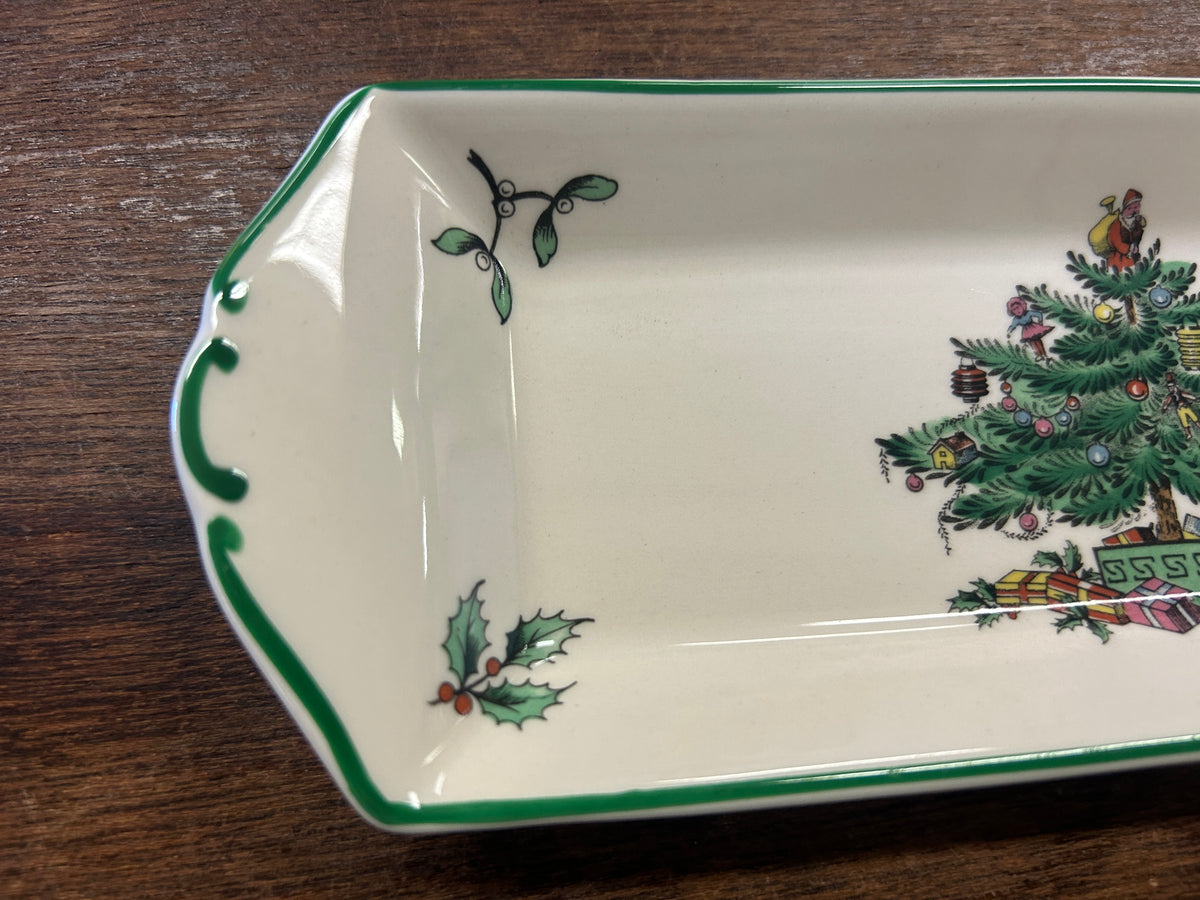 White porcelain corner of Christmas tree platter with holly and vine accents, green border