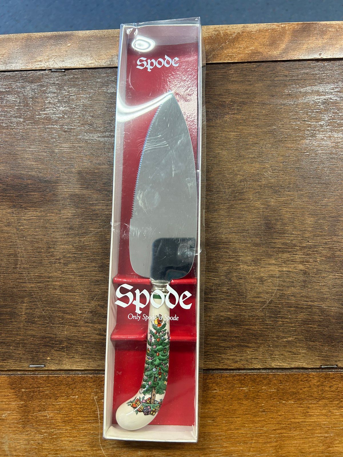 Spode Christmas cake server in clear box, red tree motif handle and steel blade
