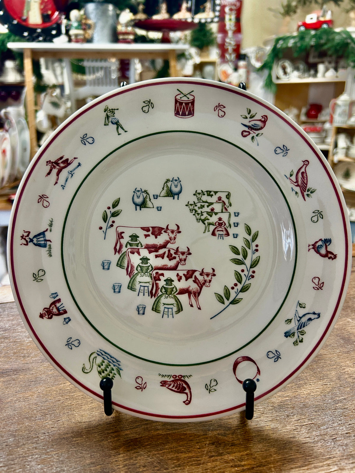 Decorative Christmas plate with multicolor farm-animal scene and red border