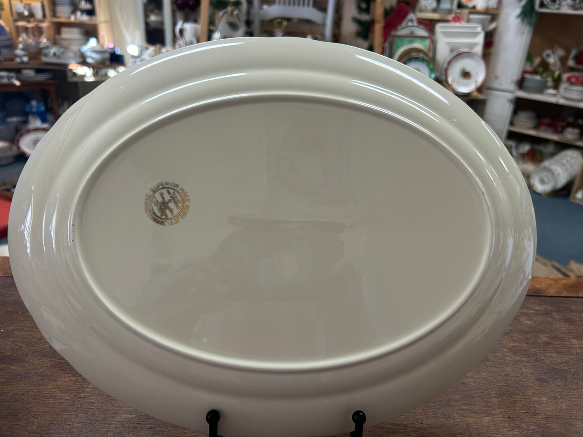 White oval serving platter base with small round maker mark