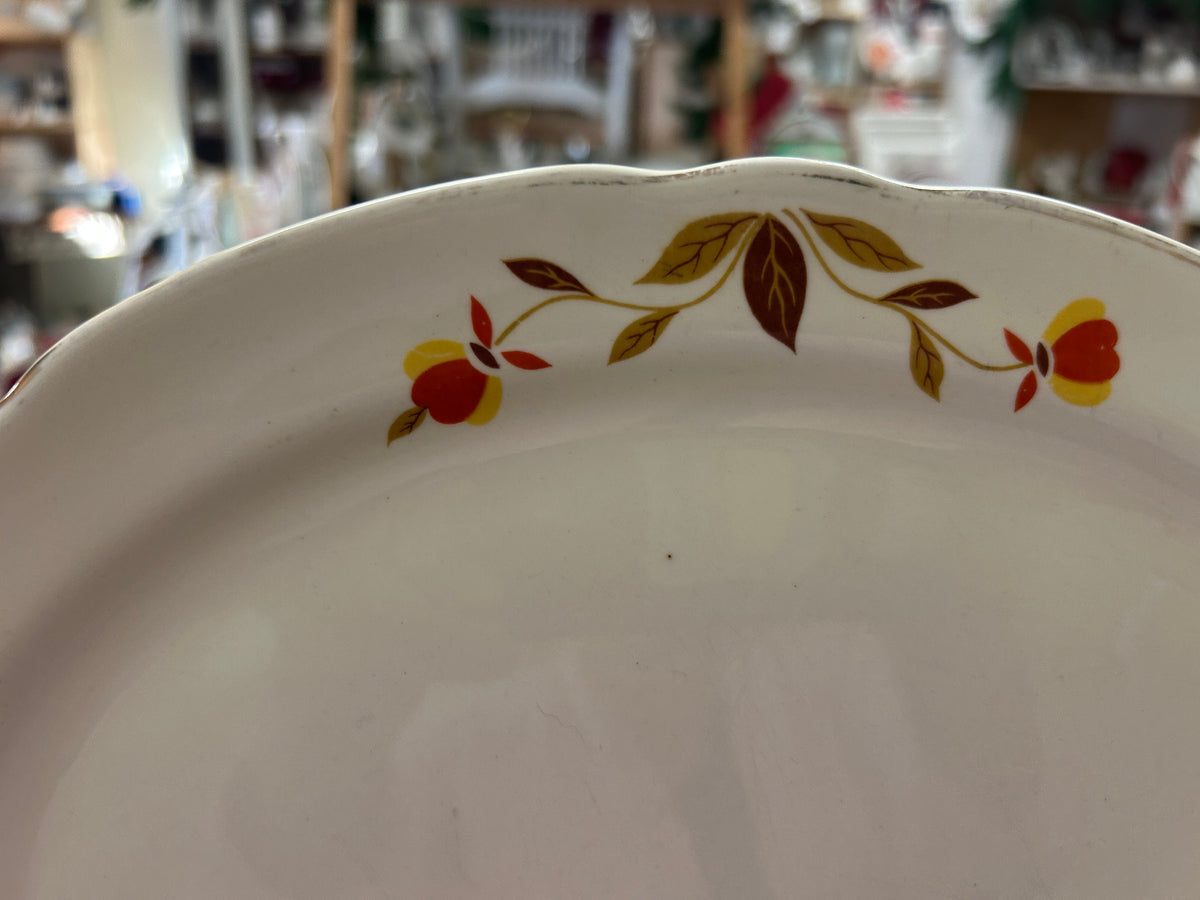White ceramic platter with multicolor autumn leaf branch design near the rim