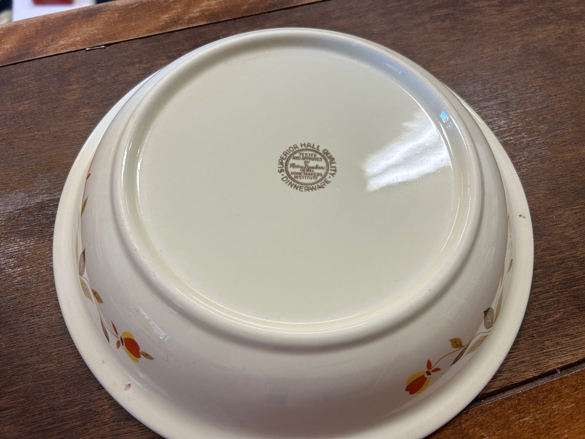 White ceramic pie plate bottom with circular stamp and small fall leaf pattern