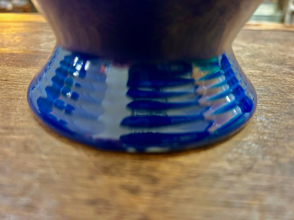 Close-up of the coffee pot's ribbed cobalt blue pedestal base