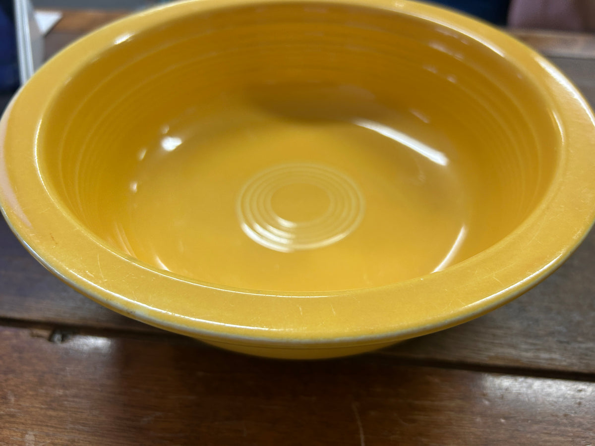 Fiestaware yellow rimmed bowl, 8.5 inches, showing its wide rim and concentric base rings