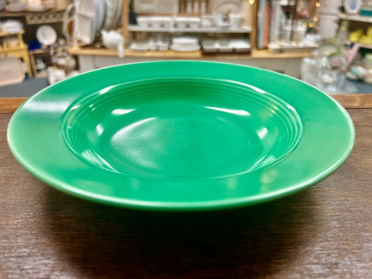 Vintage green ceramic bowl from above, showing concentric interior ridges.