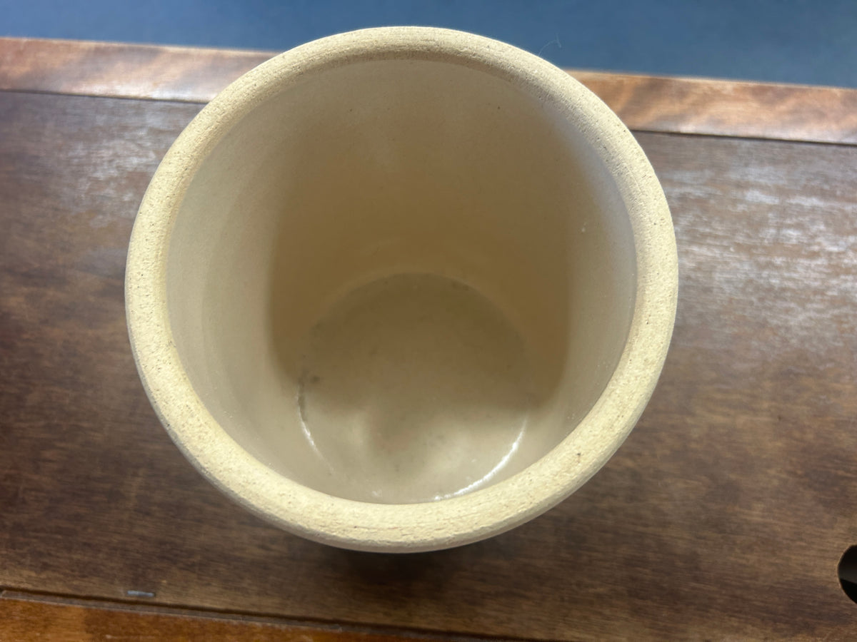 Crock viewed from above, showing its empty cream-colored interior and thick rim.