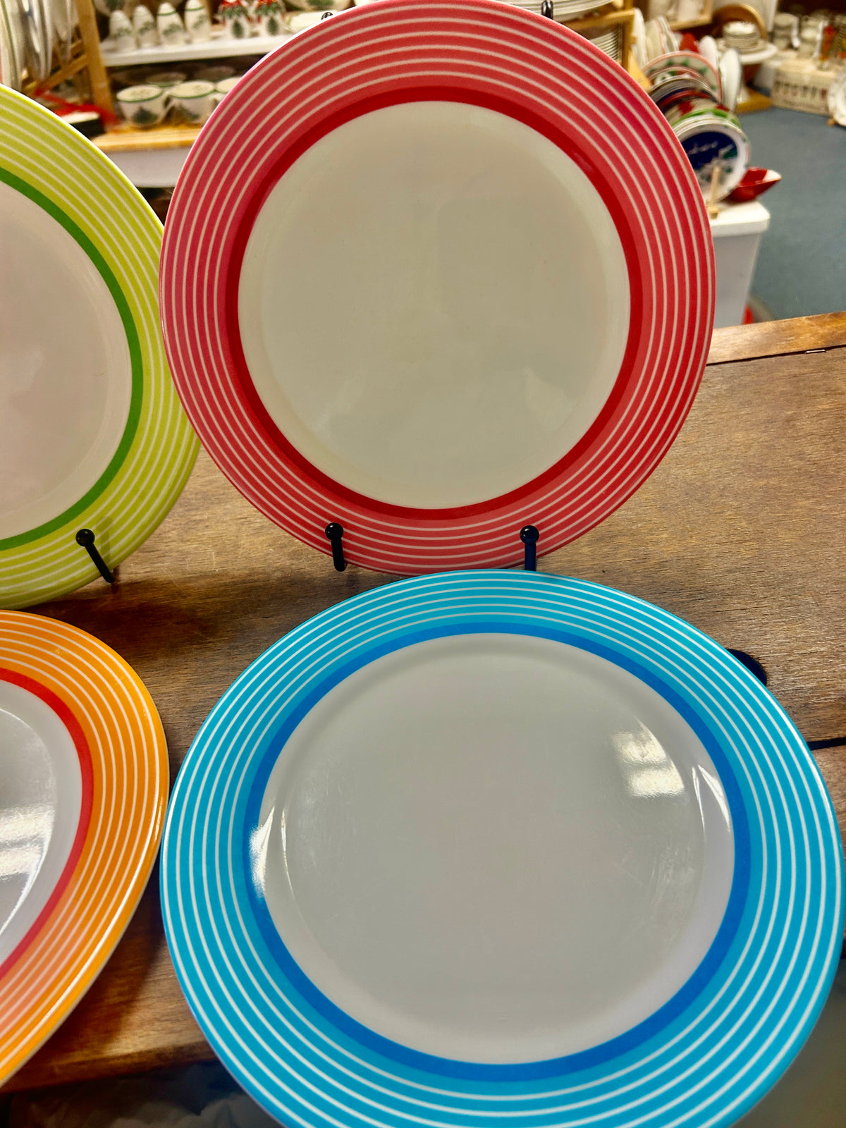 Red and blue striped melamine plates with white centers and matching inner rings.