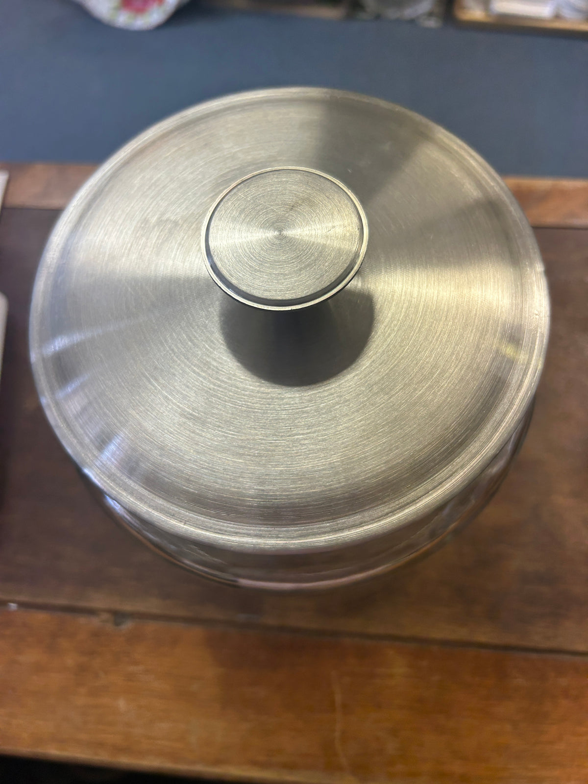 Close-up of the canister's brushed metal lid and central knob