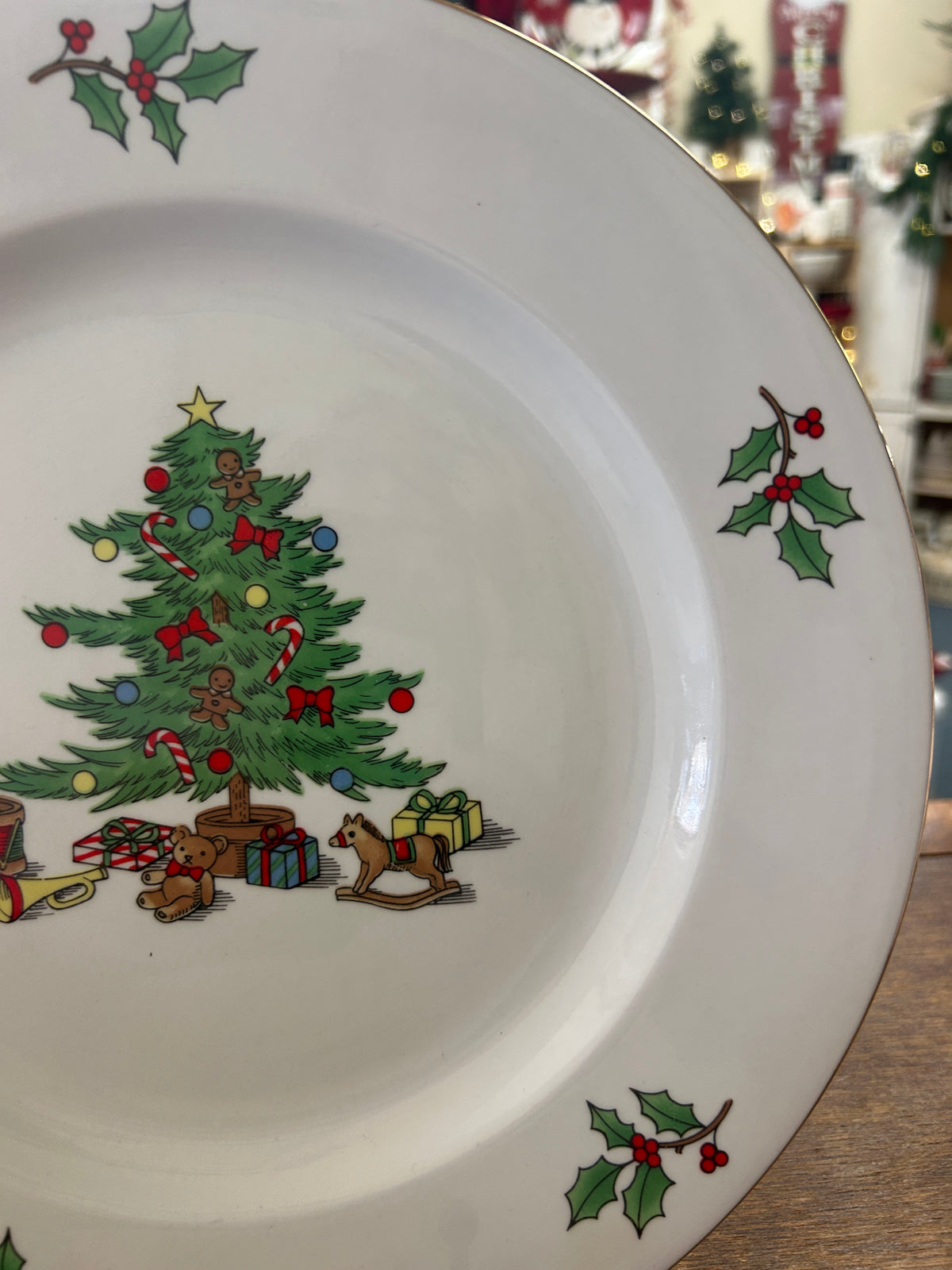 Meiwa holiday plate detail with a Christmas tree, gifts, rocking horse, and holly
