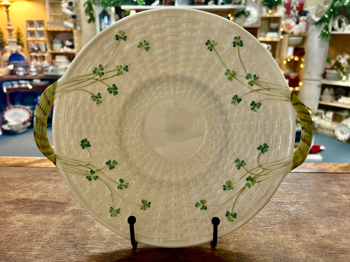 Cream Belleek platter with green shamrocks, basketweave texture, and two handles