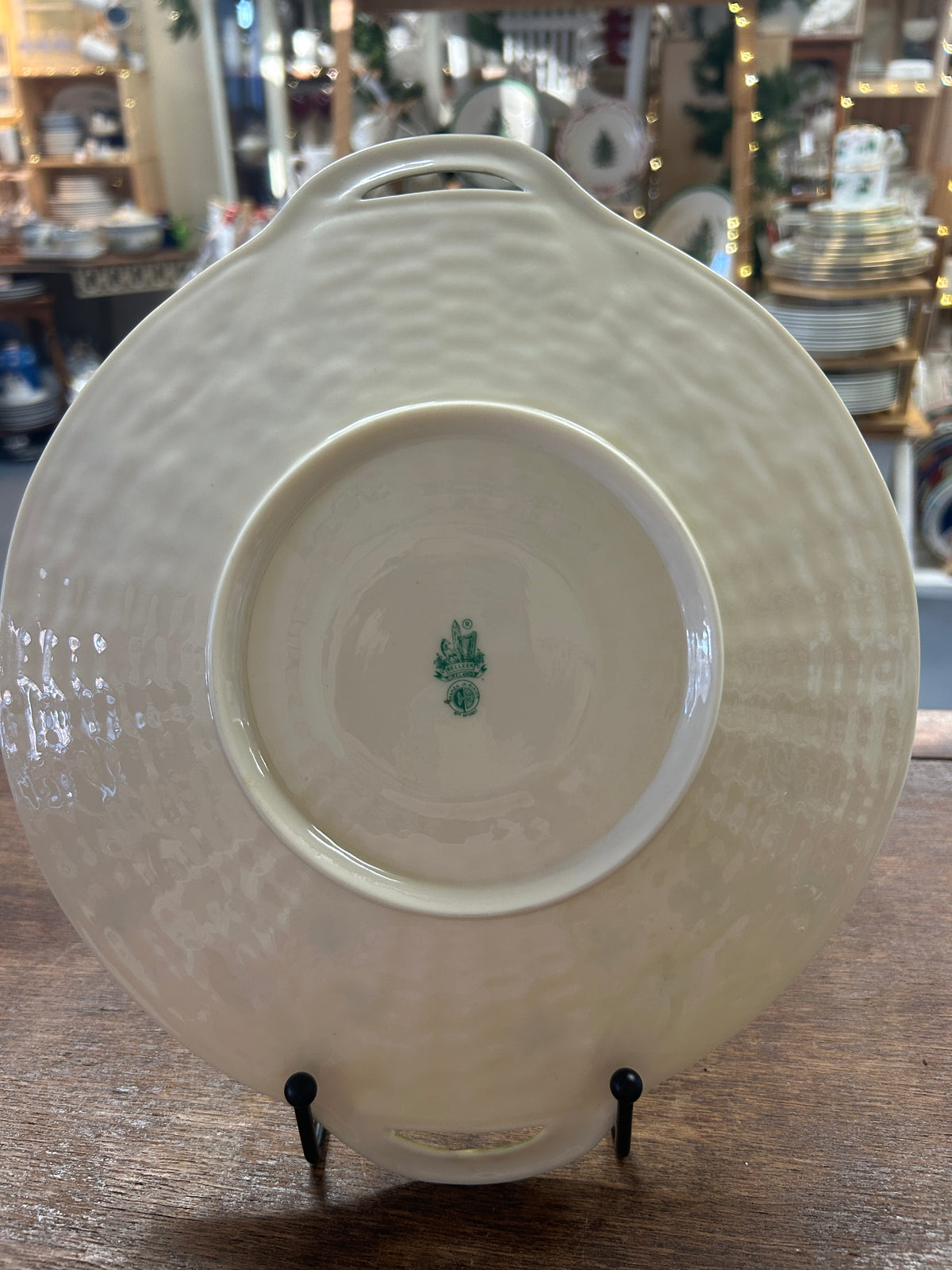 Back of the cream platter with raised foot ring, maker's mark, and handle