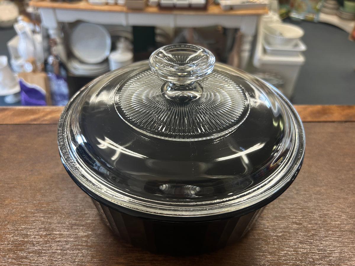 Black Corningware baking dish with metal lid and knob, top view
