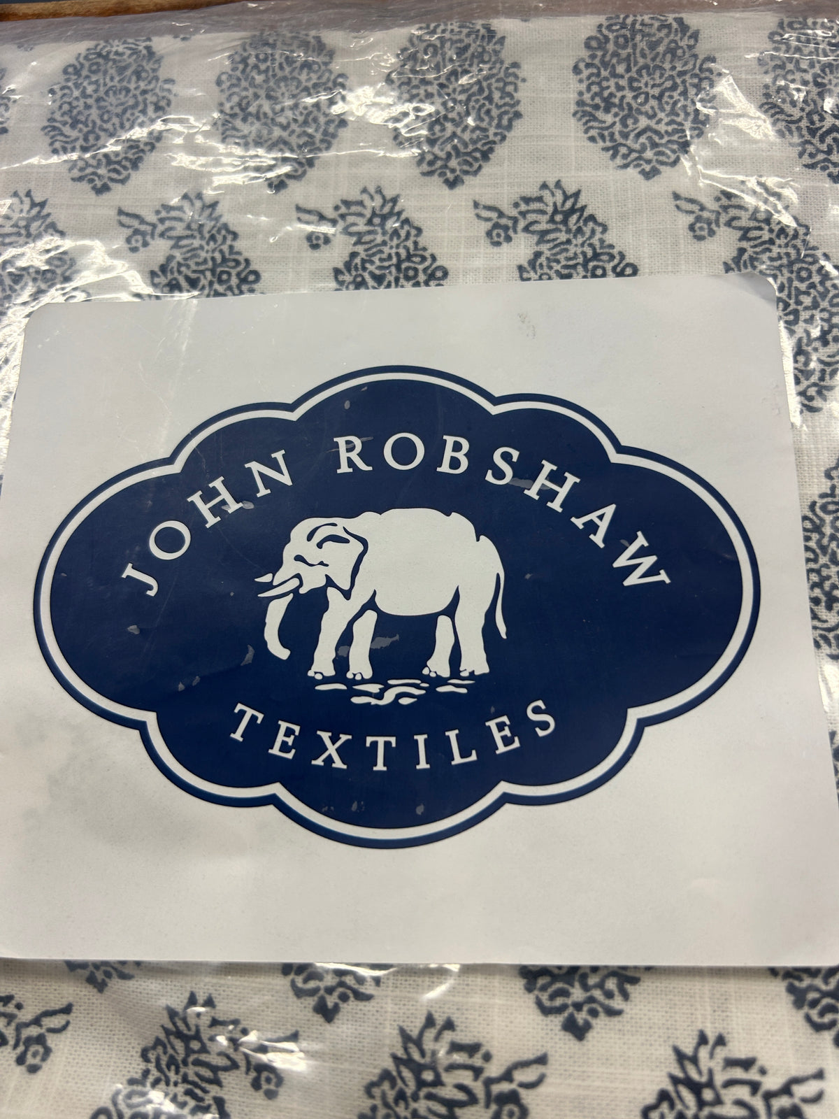 Blue and white napkins with John Robshaw Textiles logo label on top