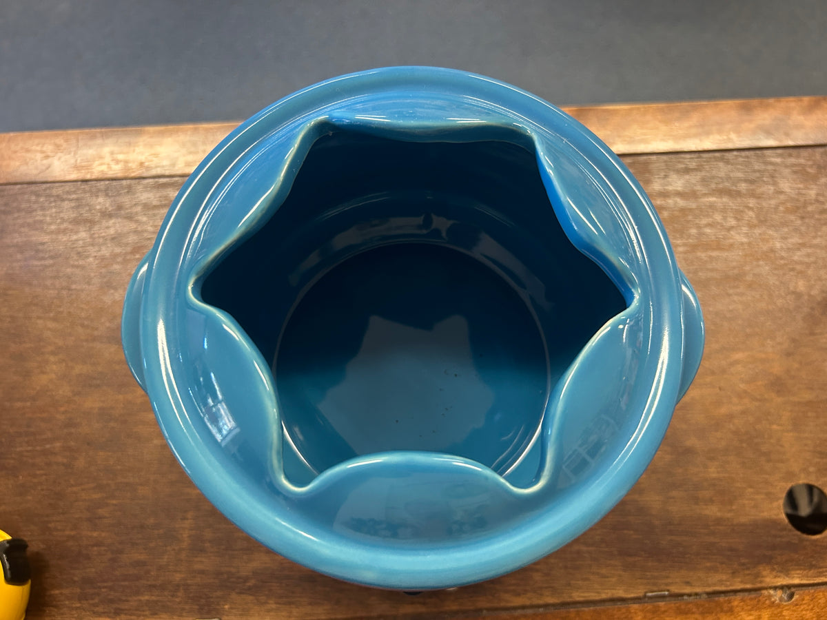 Ombre blue ceramic fondue pot viewed from above, open interior with curved rim