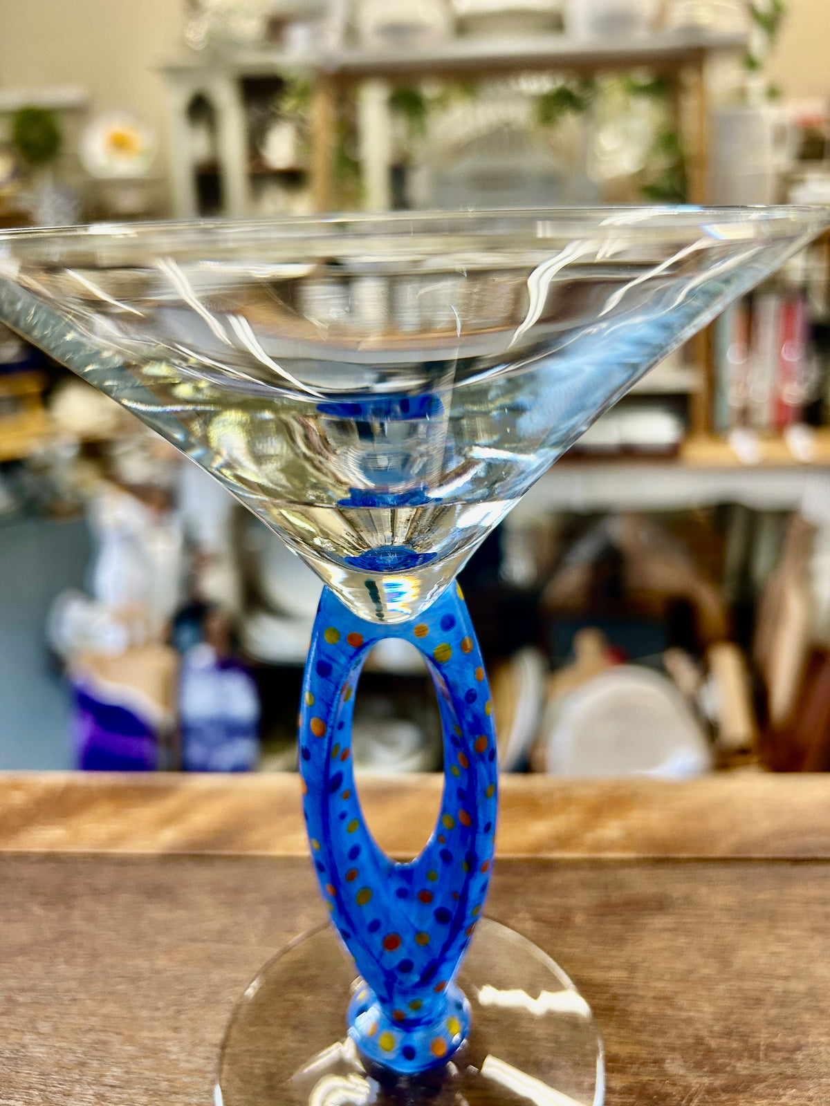 Blue cut-out martini glass with faceted rim and dotted blue stem, front view