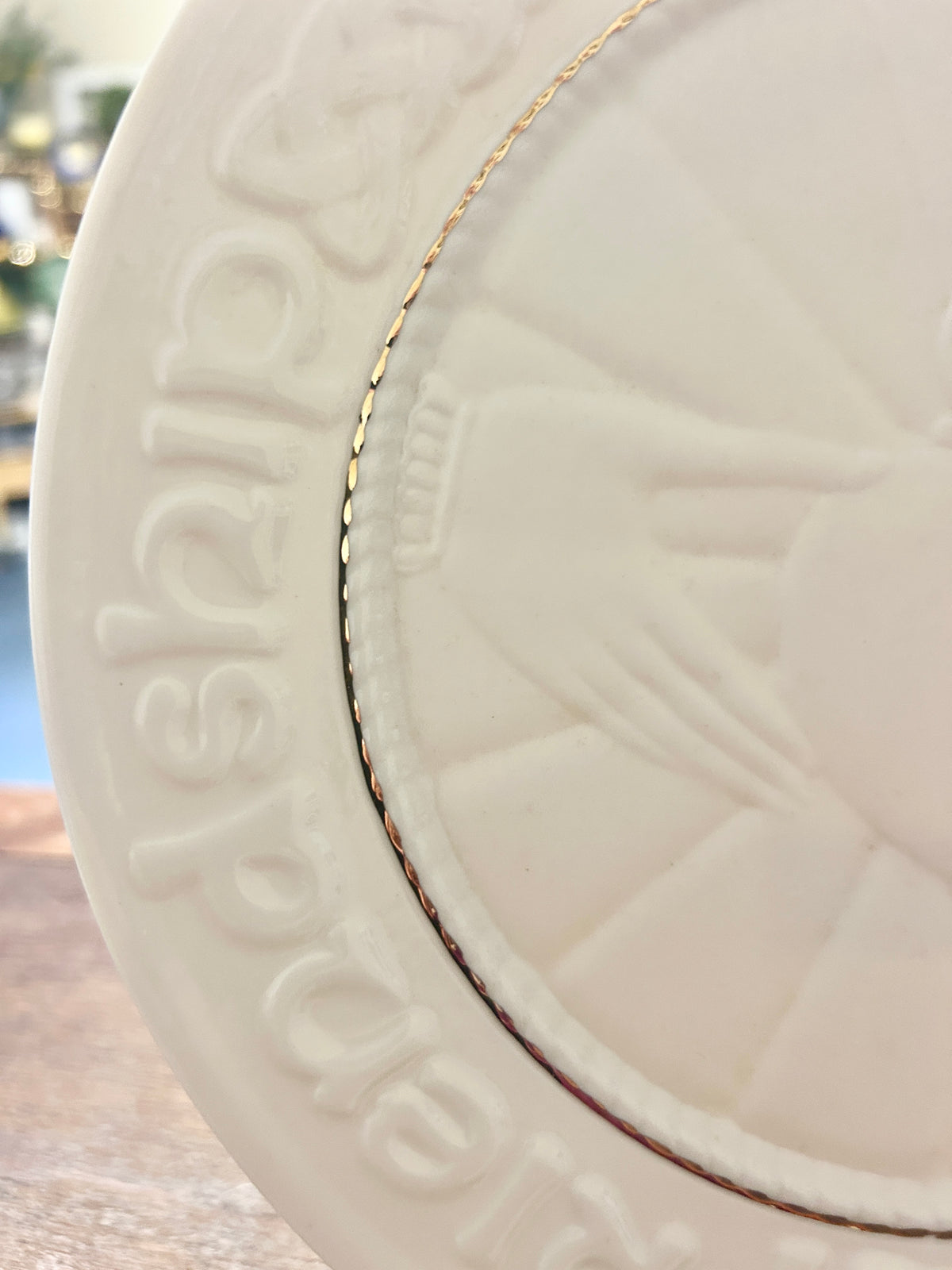 White ceramic heart box lid detail with embossed Claddagh heart and gold edging