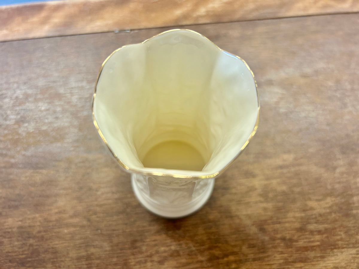 White ceramic vase interior view with gold-trimmed scalloped rim