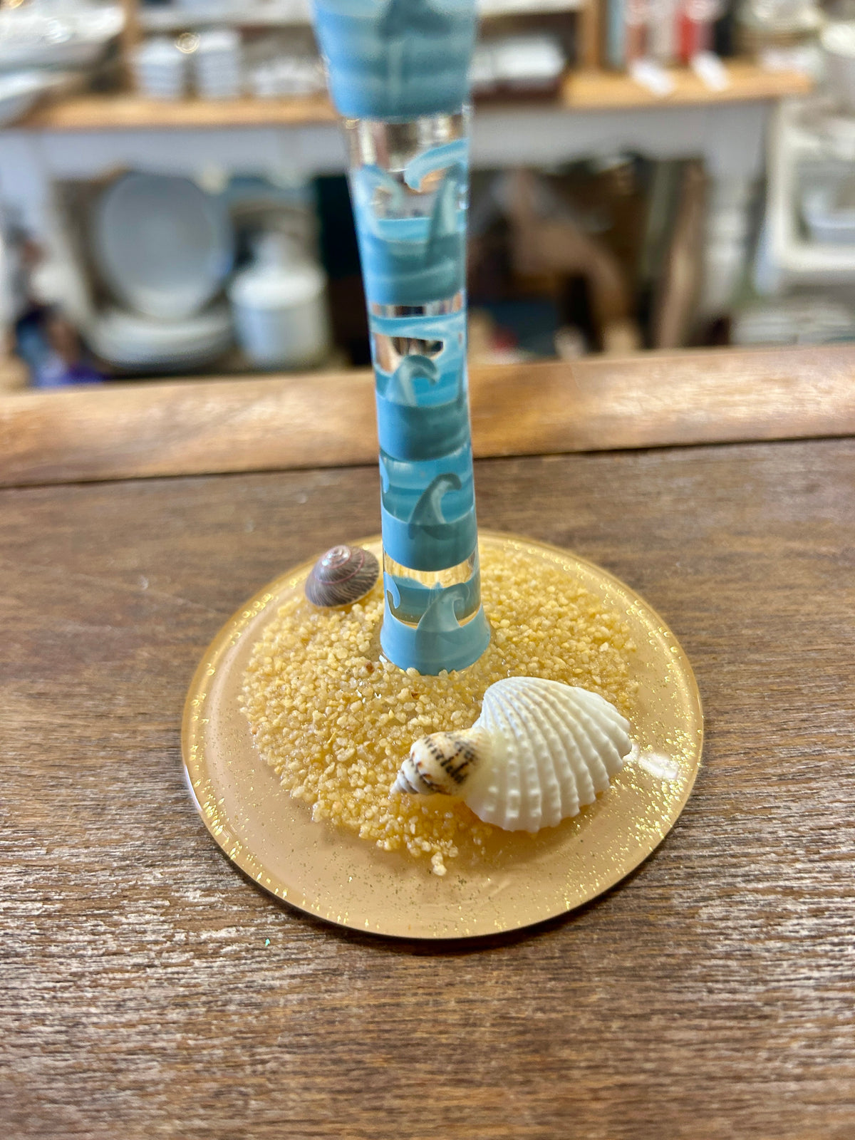 Beach themed wine glass base: blue striped stem with seashell ornament on plate