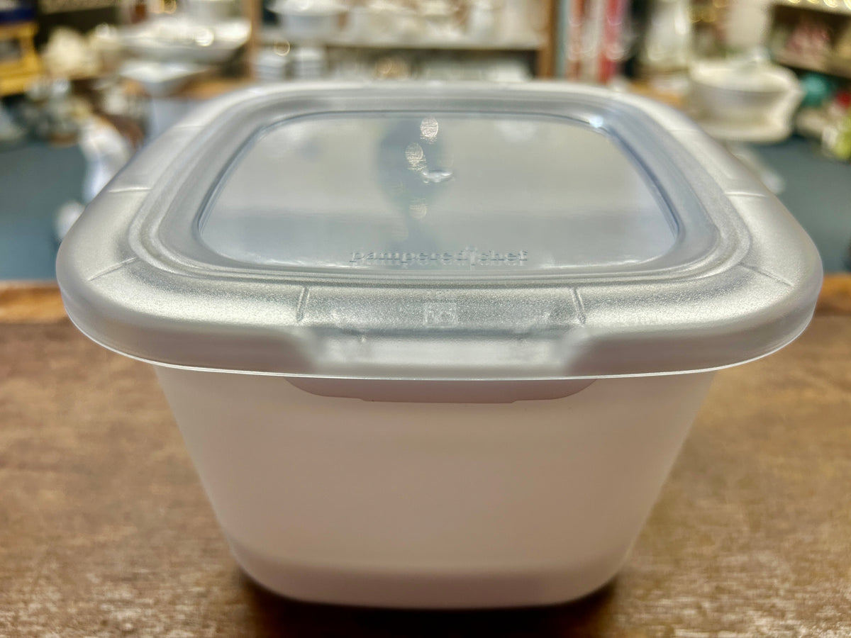 White Pampered Chef 1-qt bowl with clear oval lid, front view