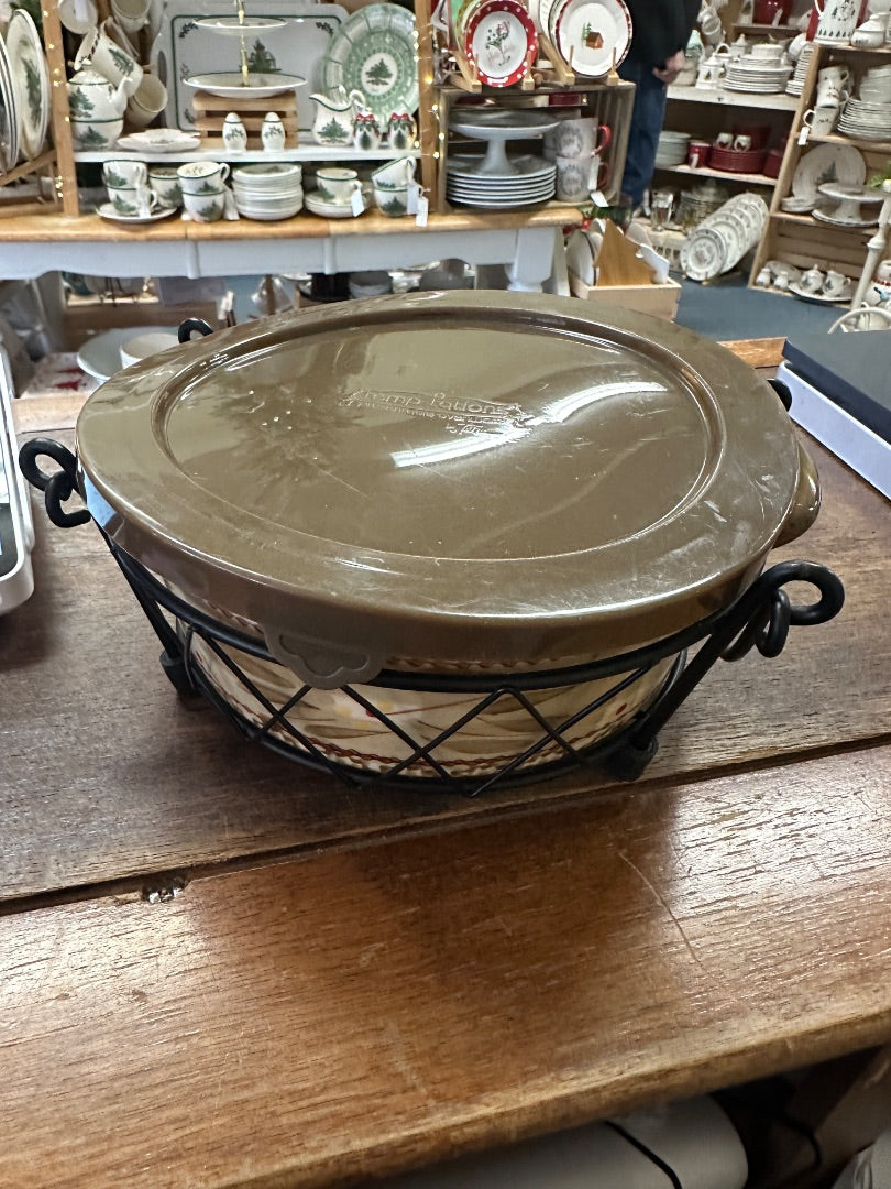 Brown-toned baking dish lid on metal wire rack with side handles
