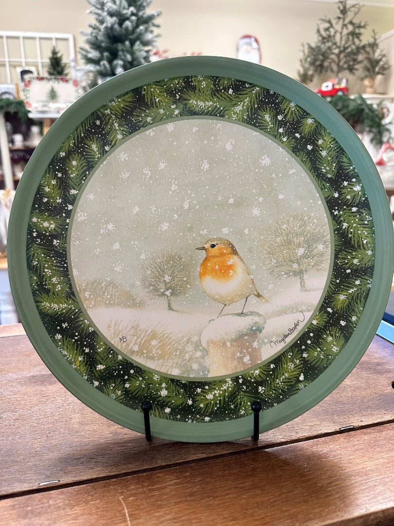 Decorative plate with green rim, pine branches, and robin in snowy scene