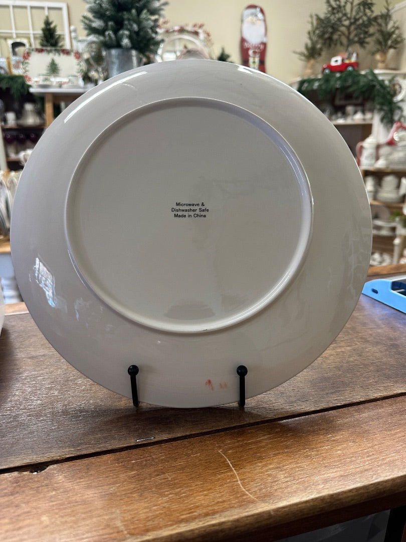 White ceramic recipe platter back with small printed text, round shape on stand