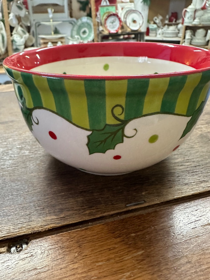 Small ceramic bowl with red rim, green striped sides, holly leaves and dotted accents