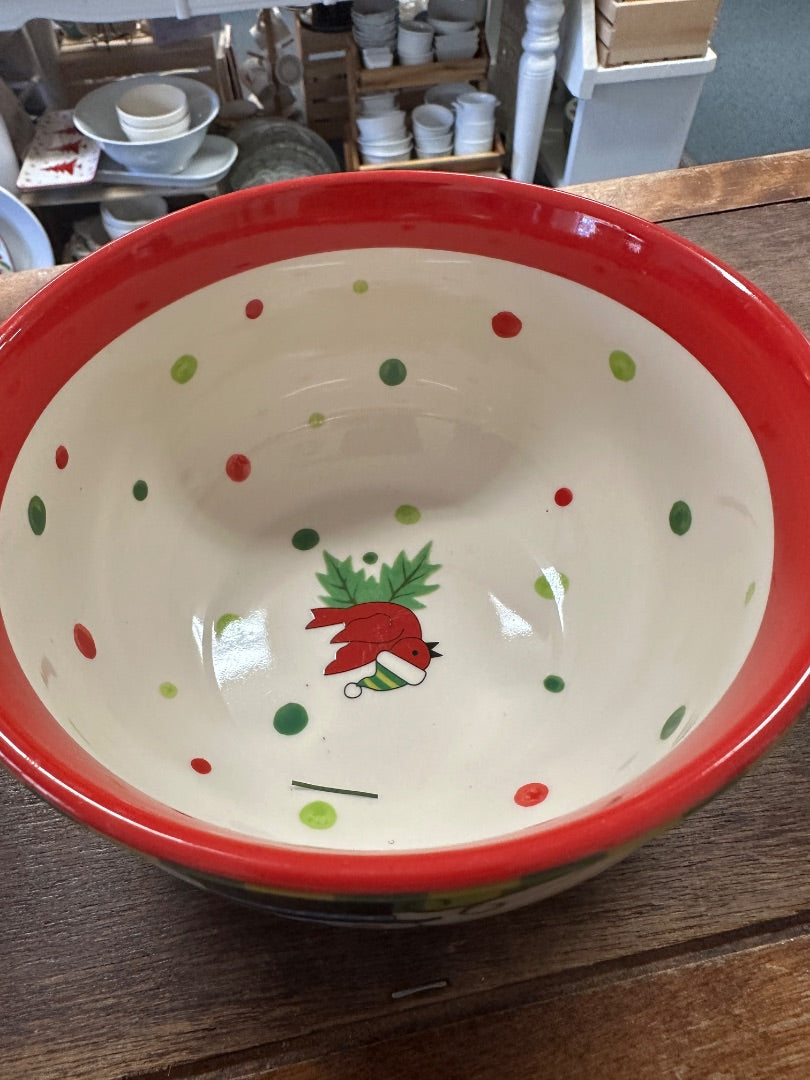 Ceramic bowl with red rim, holly dot pattern, and small nutcracker design