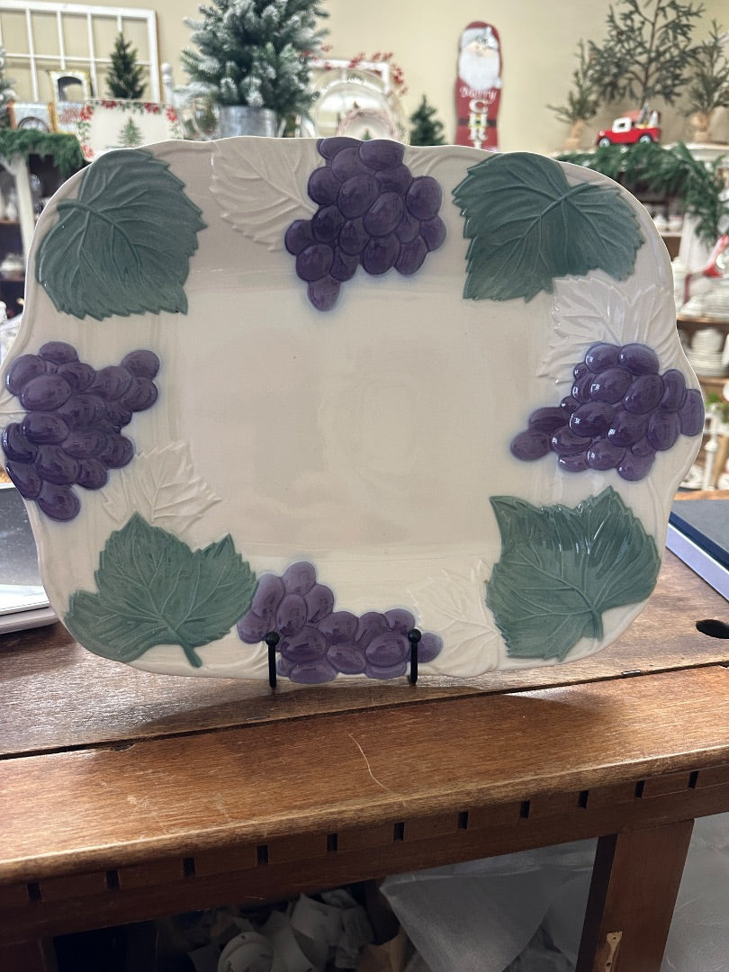 White ceramic platter with purple grape clusters and green leaf accents