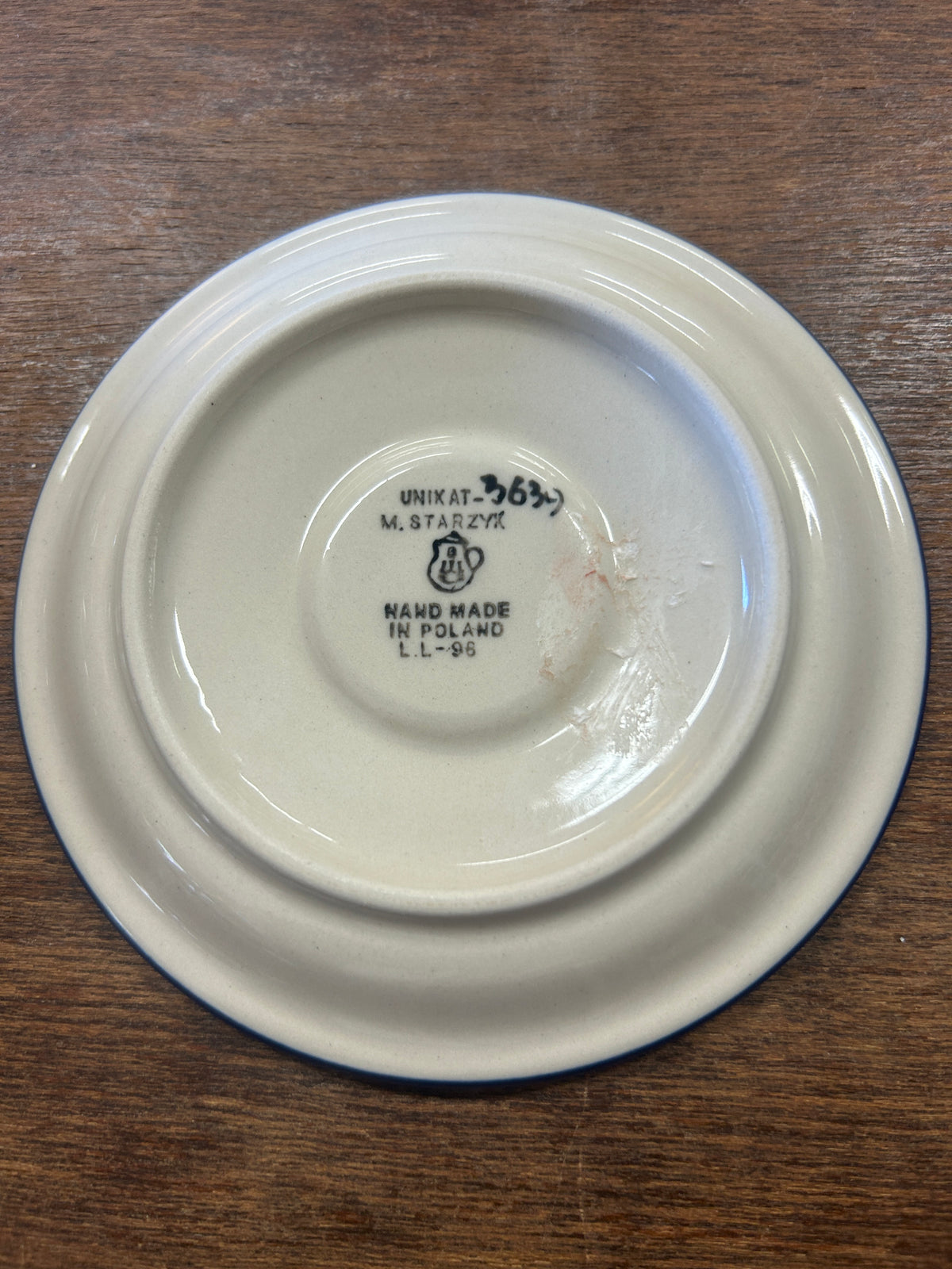 Back of ceramic plate with UNIKAT stamp and handmade marking on base