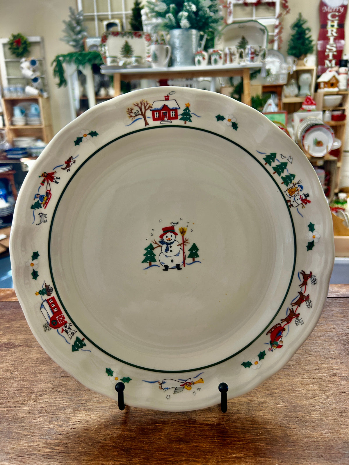 11-inch dinner plate with winter snowman and village border in red and green