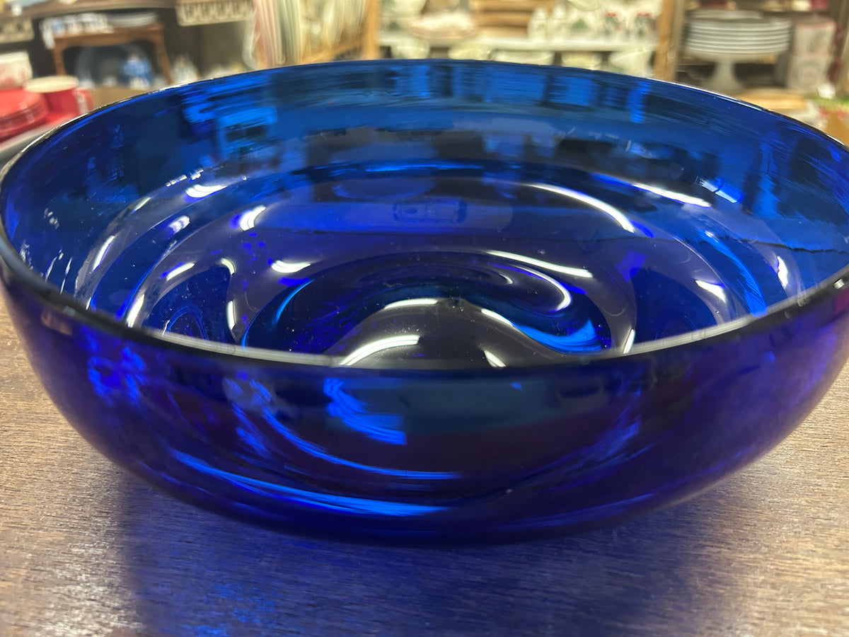 Cobalt blue footed bowl with glossy reflective surface and round basin