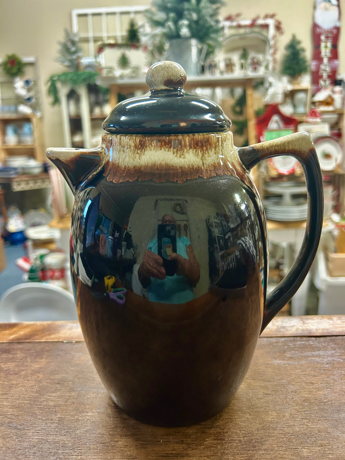 Brown ceramic drip coffee pot with dark teal lid and knob, side handle