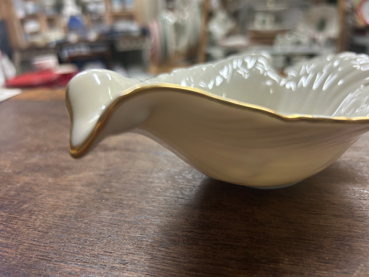 Cream Lenox dove bowl with gold rim and flared lip.