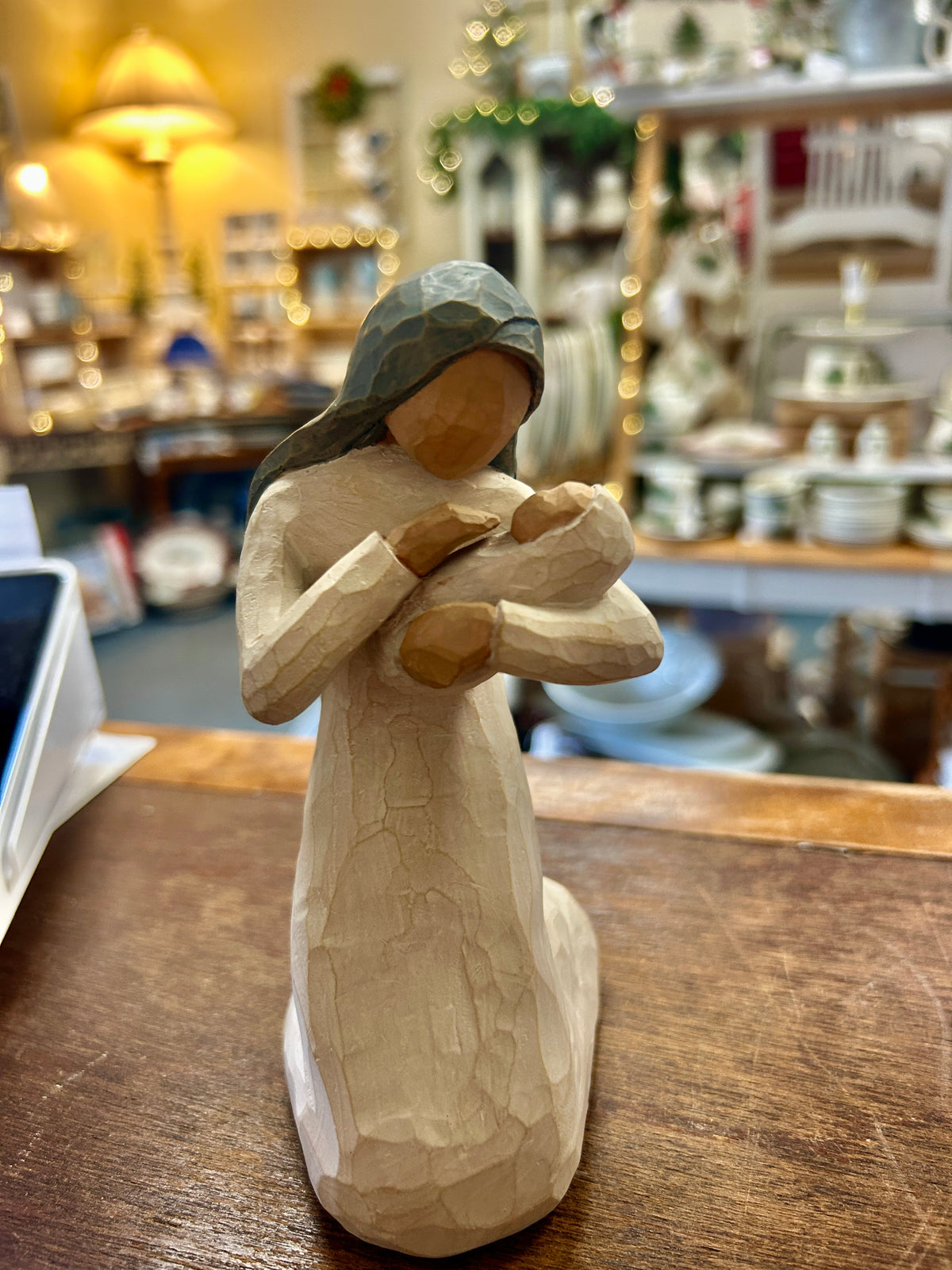 Cream Mary nativity figurine with head covering, holding a small baby figure
