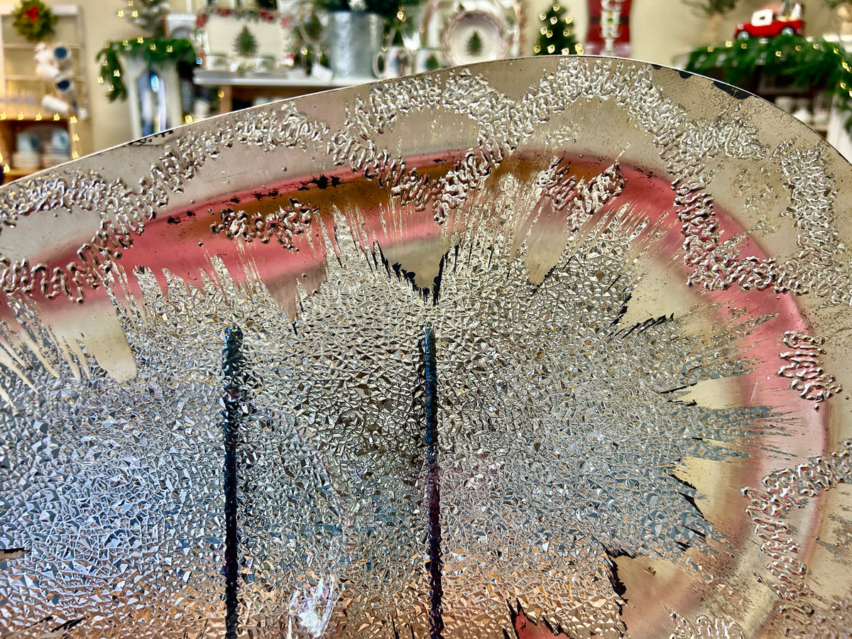Silver round divided platter with raised atomic splash design and two-section center