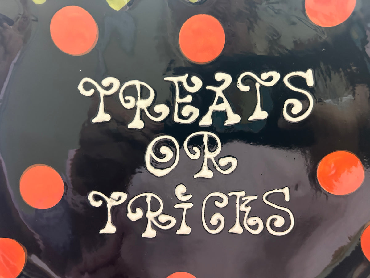 Dark Halloween cauldron platter with orange polka dots and 'Treats or Tricks' lettering
