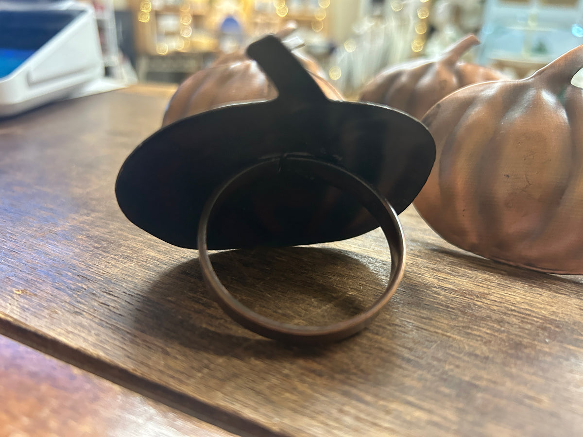 Copper pumpkin napkin ring with ring loop in front of copper pumpkins