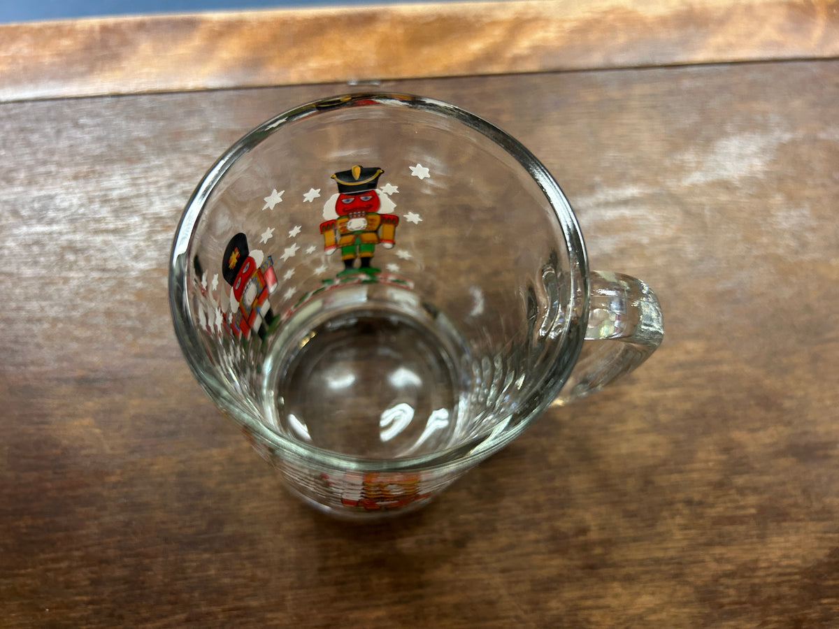 Glass mug bottom interior view with small nutcracker print near rim
