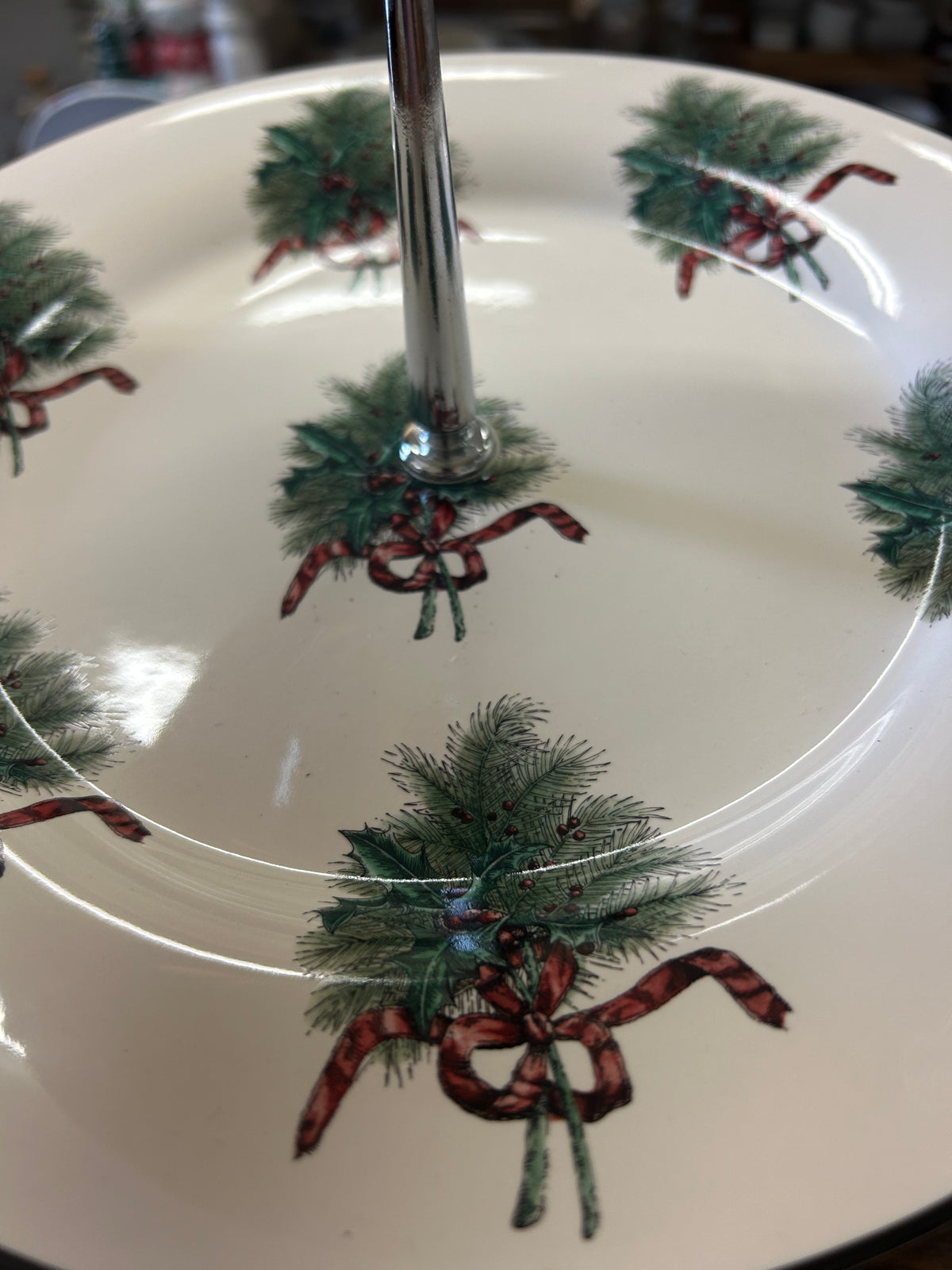 Top plate with green pine wreath and red bow holiday motif on white ceramic