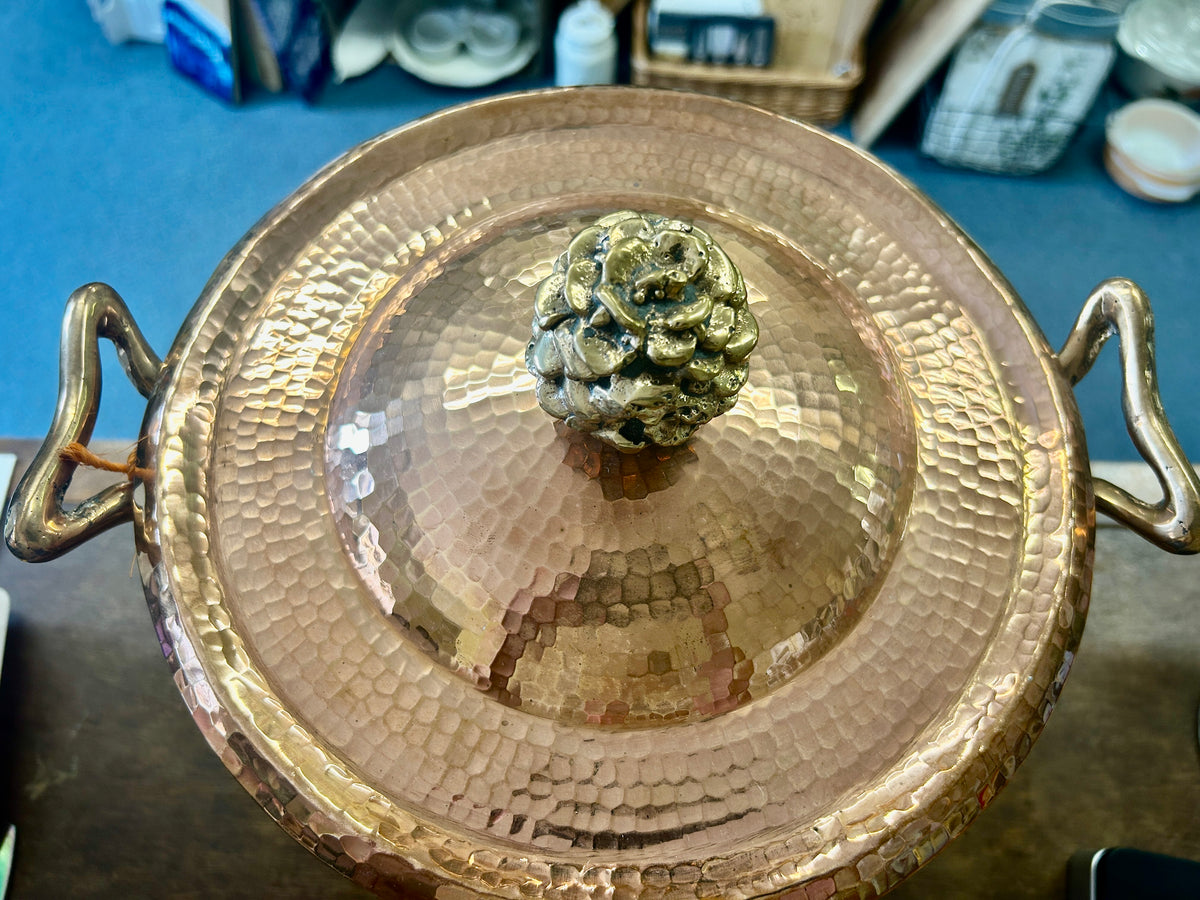 Copper lid with flower knob and two loop handles on hammered finish
