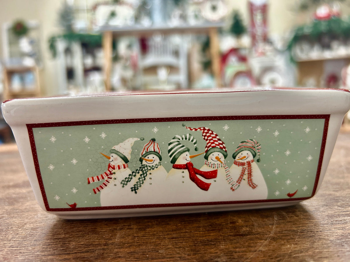 Holiday mini loaf pan with red border and snowman scene on white ceramic
