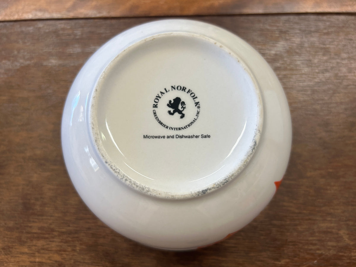 White ceramic bowl base with Royal Norfolk logo and care text