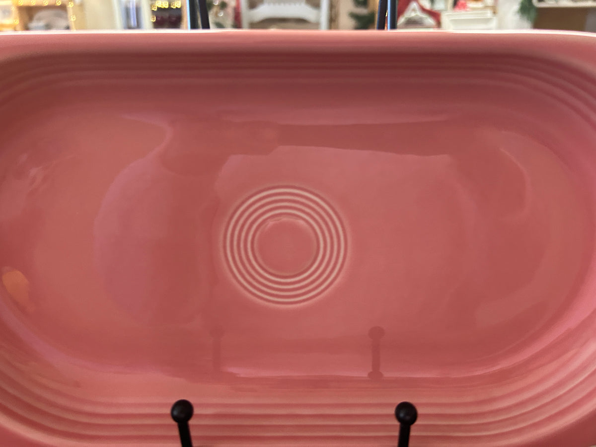 Pink oval ceramic platter showing embossed concentric circle detail