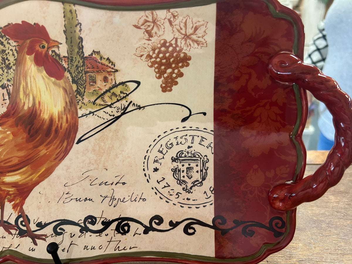 Rooster serving platter with maroon interior section and vintage stamp graphic