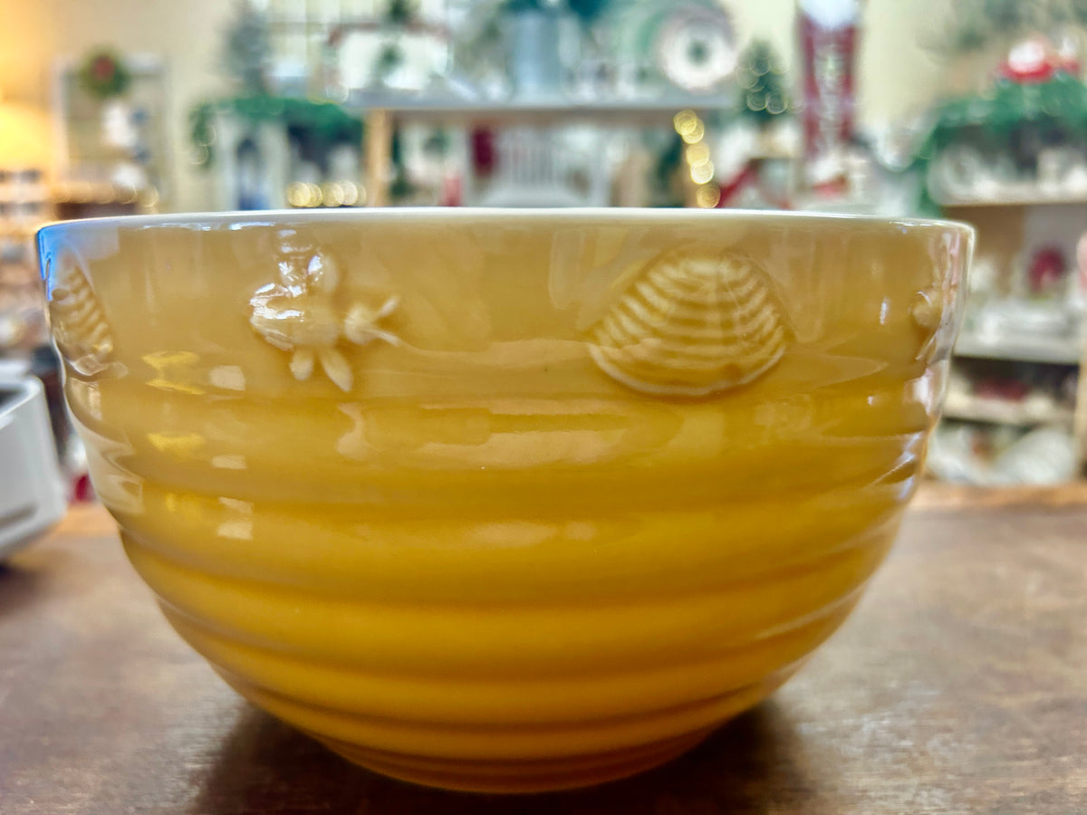 Yellow ceramic serving bowl with embossed bee and flower details