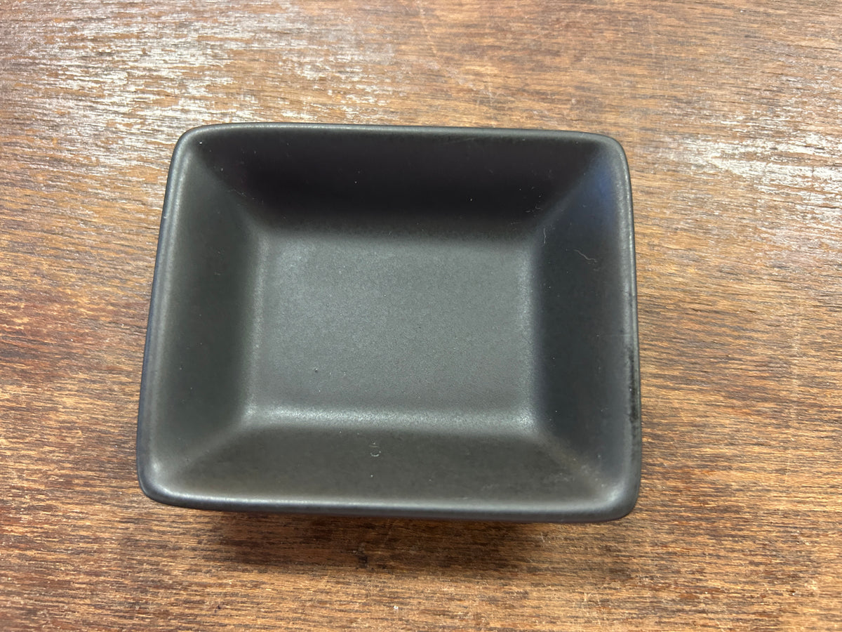 Black rectangle serving bowl with square corners and glossy finish.